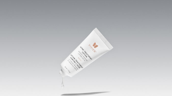 Acne treatment lotion on a grey gradient background