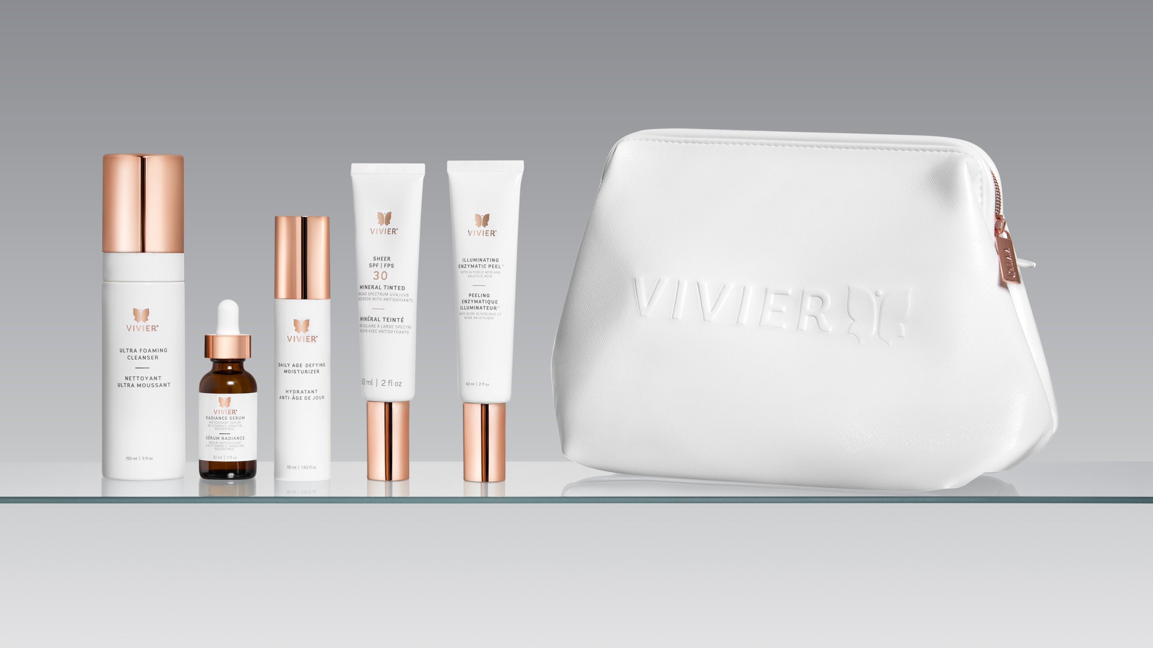 Vivier Daily Glow skincare set with cleanser, vitamin C serum, moisturizer, SPF 30, enzymatic peel, and white cosmetic bag