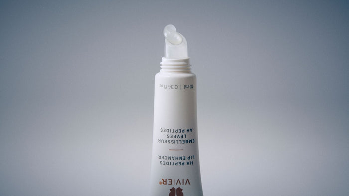 Close-up of a Vivier HA Peptides Lip Enhancer tube with a clear gel formula dispensed from the applicator.